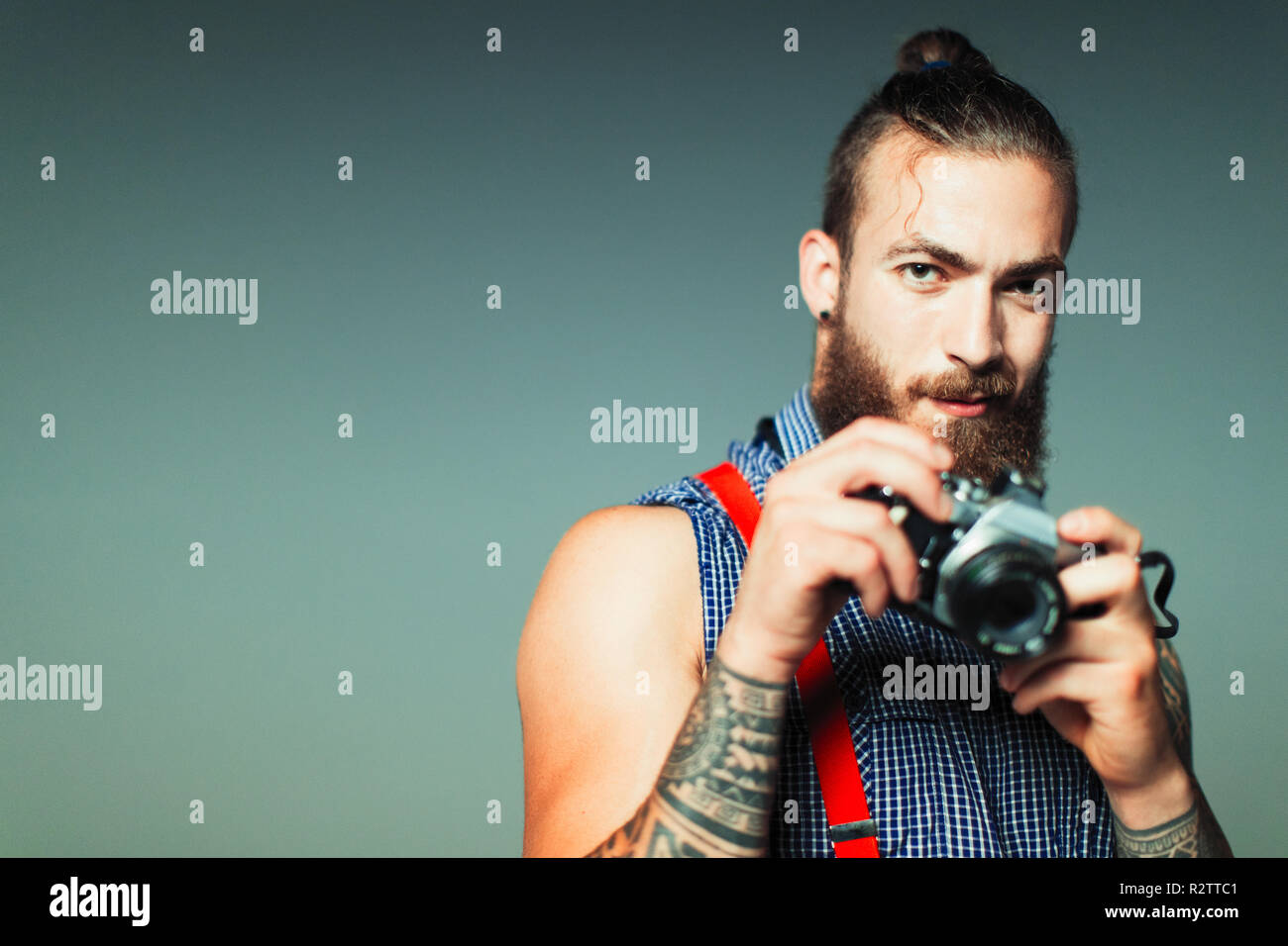 Portrait hipster man with retro camera Stock Photo