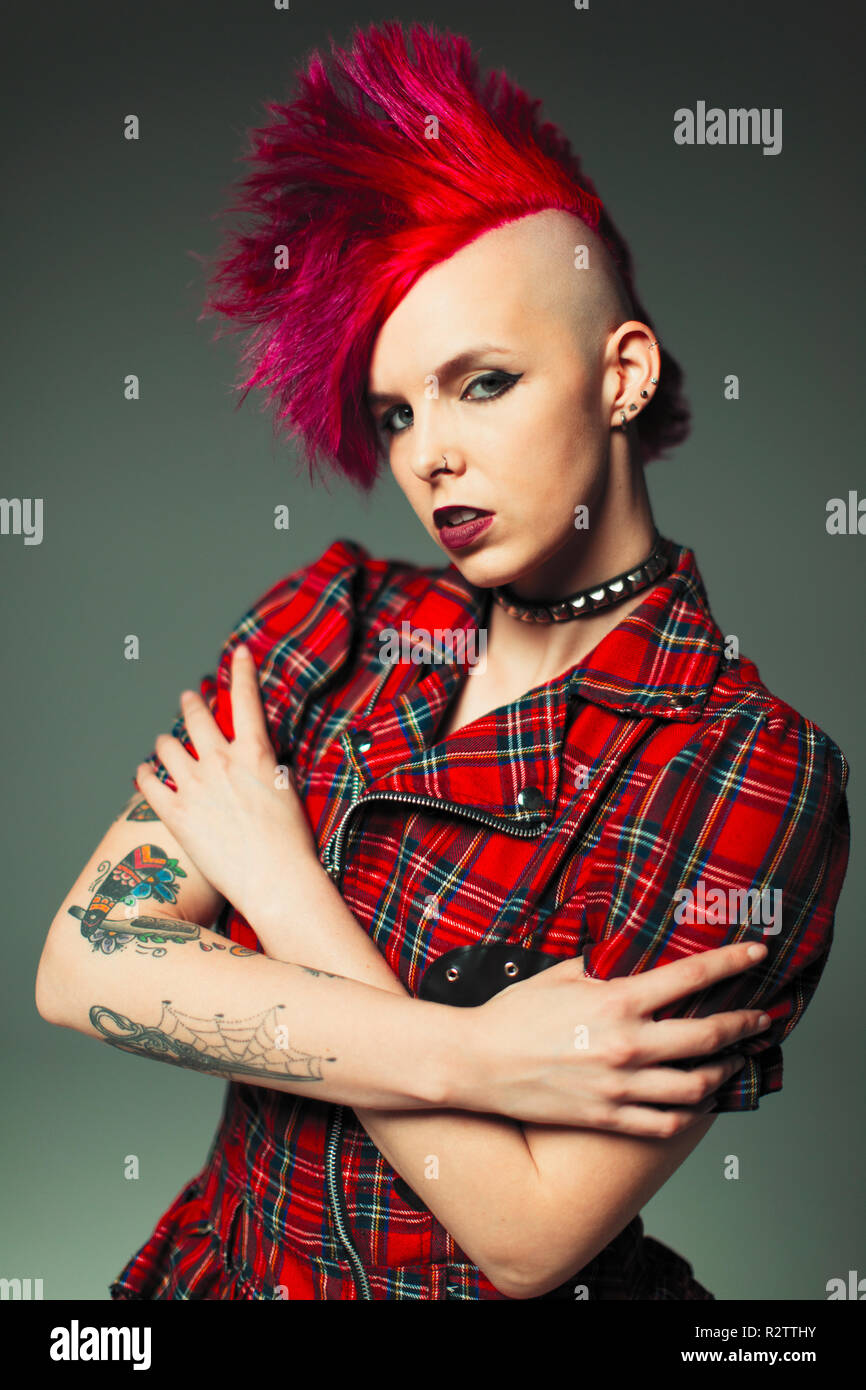 Portrait confident, cool young woman with pink mohawk and tattoos Stock Photo