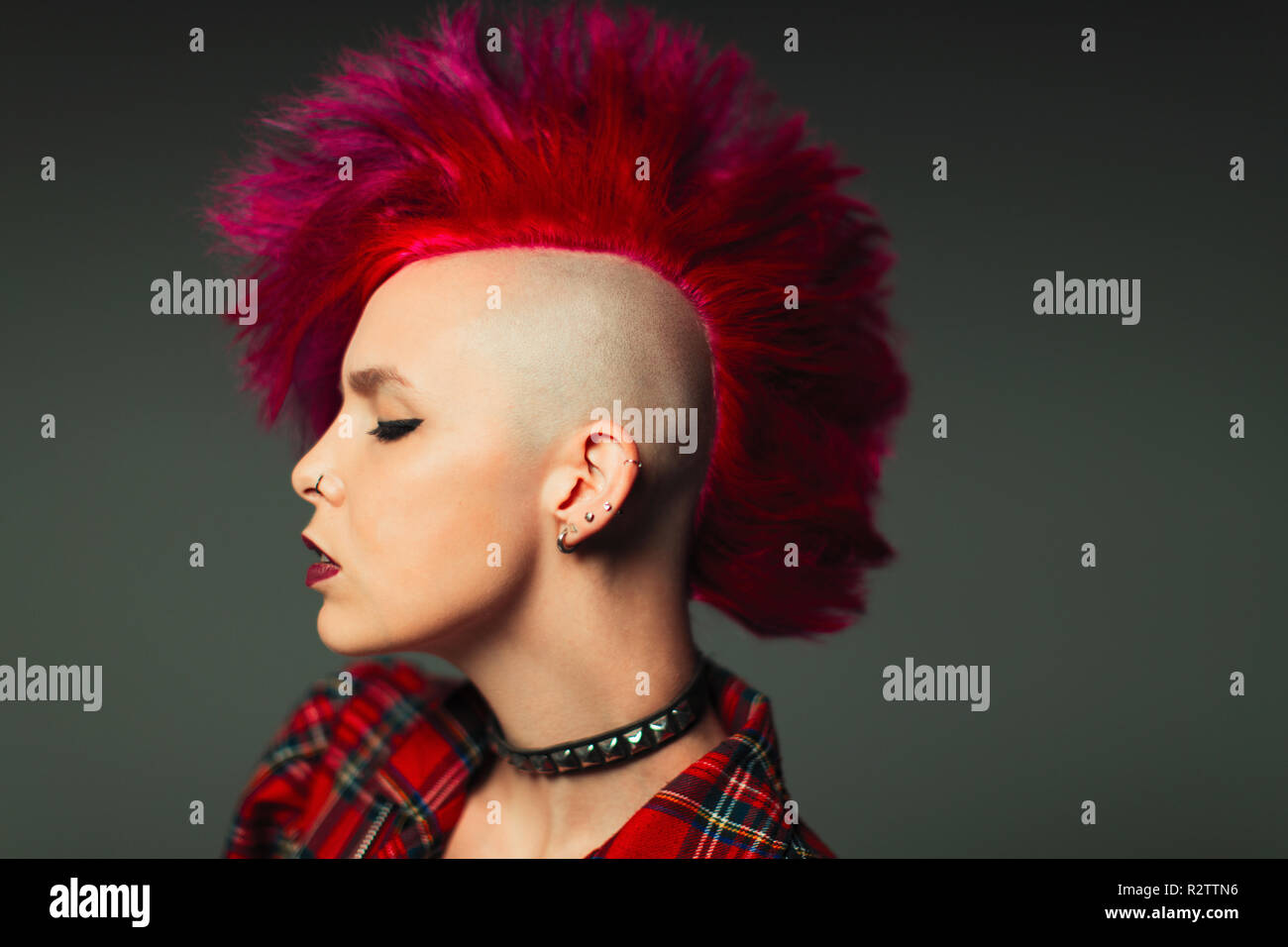 Profile portrait cool young woman with pink mohawk Stock Photo
