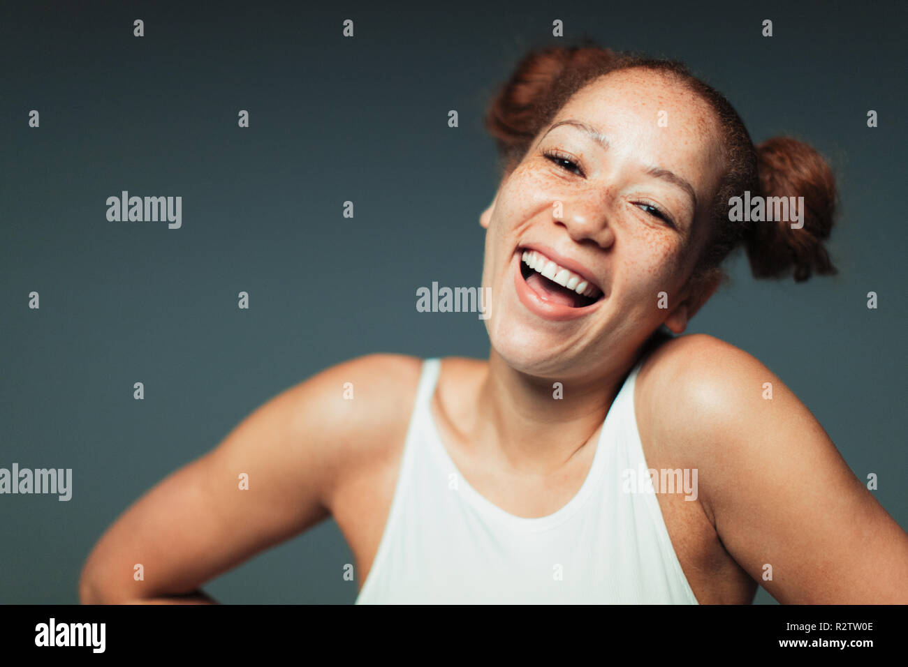 Portrait carefree woman with freckles laughing Stock Photo