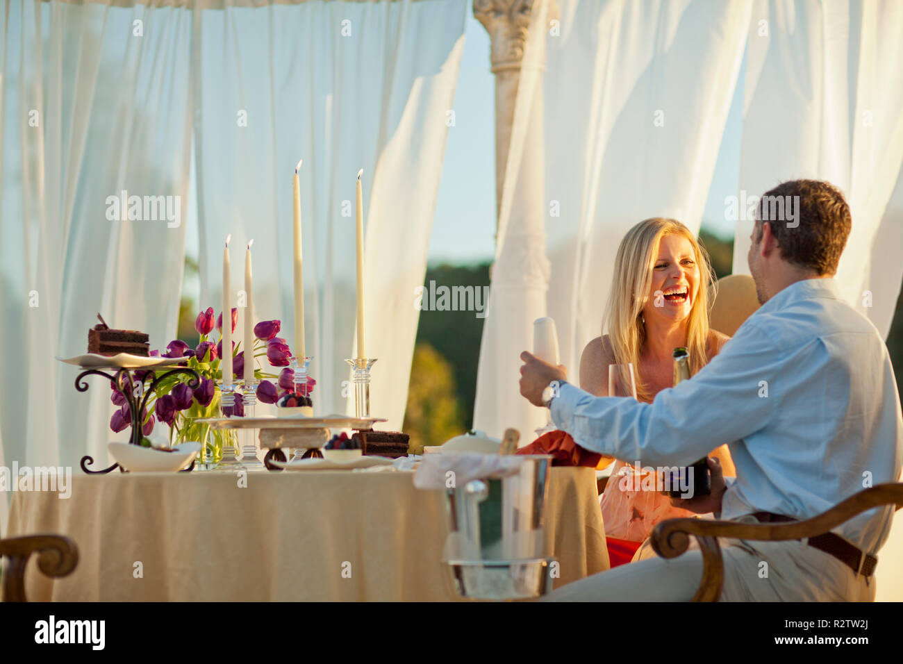 Smiling mid adult couple having a romantic dinner. Stock Photo