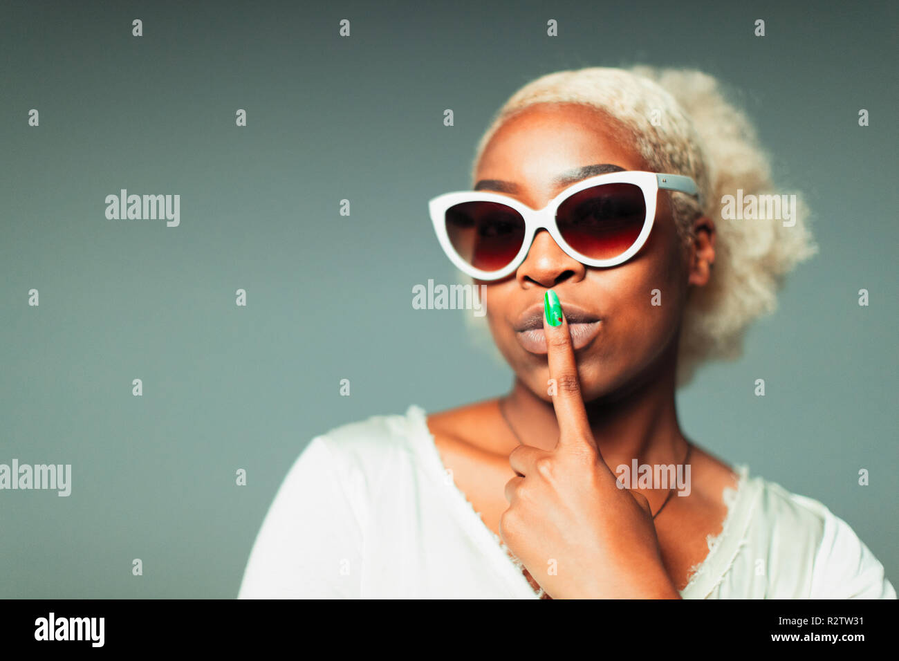 Portrait confident, cool young woman wearing retro sunglasses Stock Photo