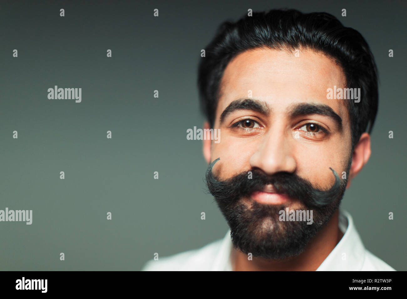 Portrait smiling, confident young man with handlebar handlebar mustache Stock Photo
