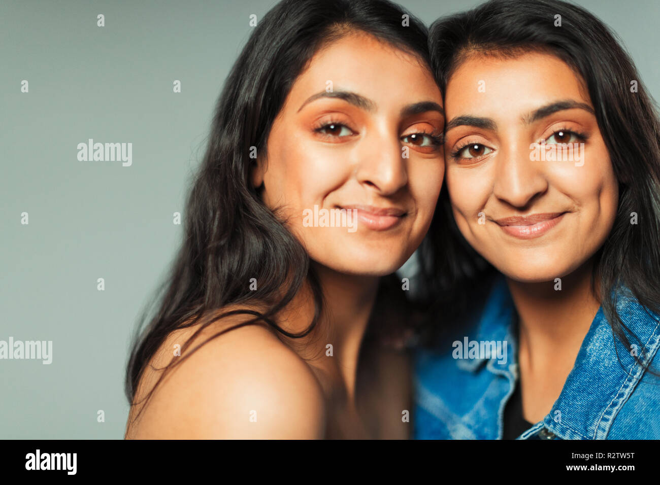 Portrait smiling, confident teenage twin sisters Stock Photo