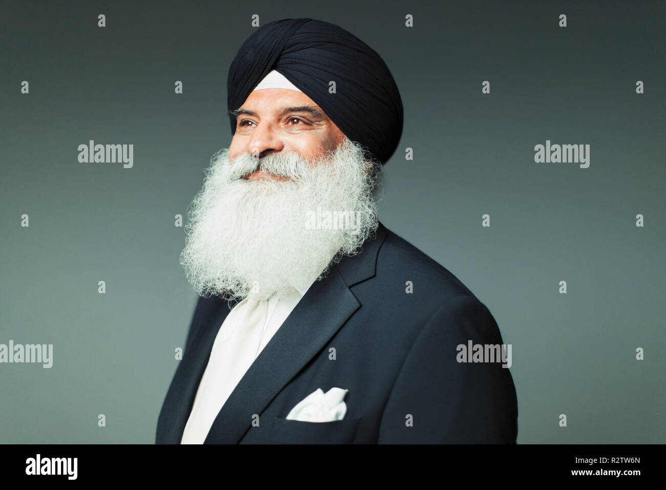 Portrait confident, well-dressed senior man with beard wearing turban Stock Photo