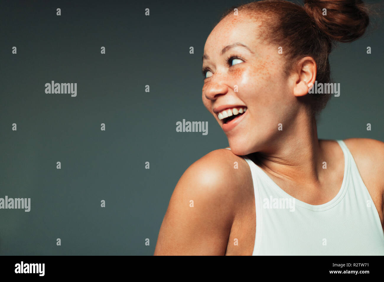 Portrait playful, curious woman looking over shoulder Stock Photo