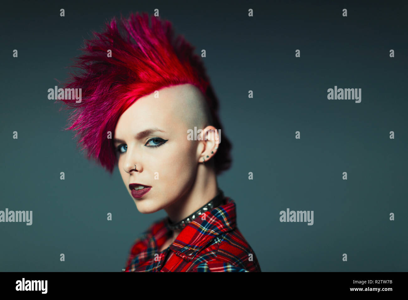 Portrait confident, cool young woman with pink mohawk Stock Photo