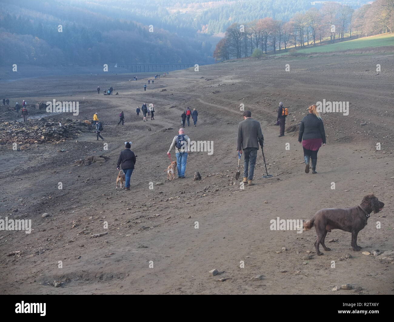 Curious crowds explore what is normally the bottom of Ladybower Reservoir to visit the remains of Derwent Village, exposed following 2018 heatwave Stock Photo