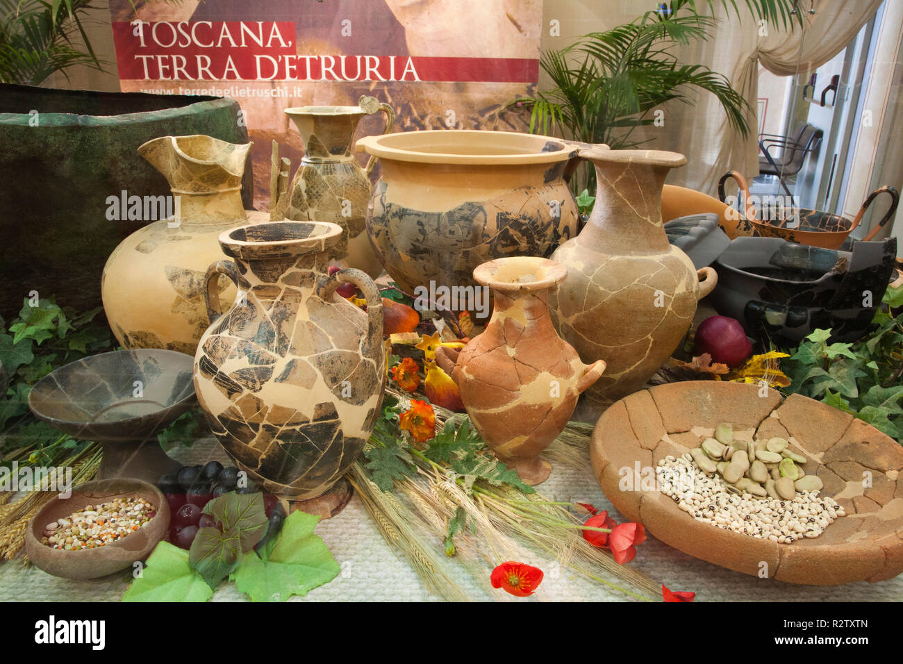 europe, italy, tuscany, vetulonia, archaeological museum, exibition, etruscan food, table laden with pots and utensils for banquet Stock Photo