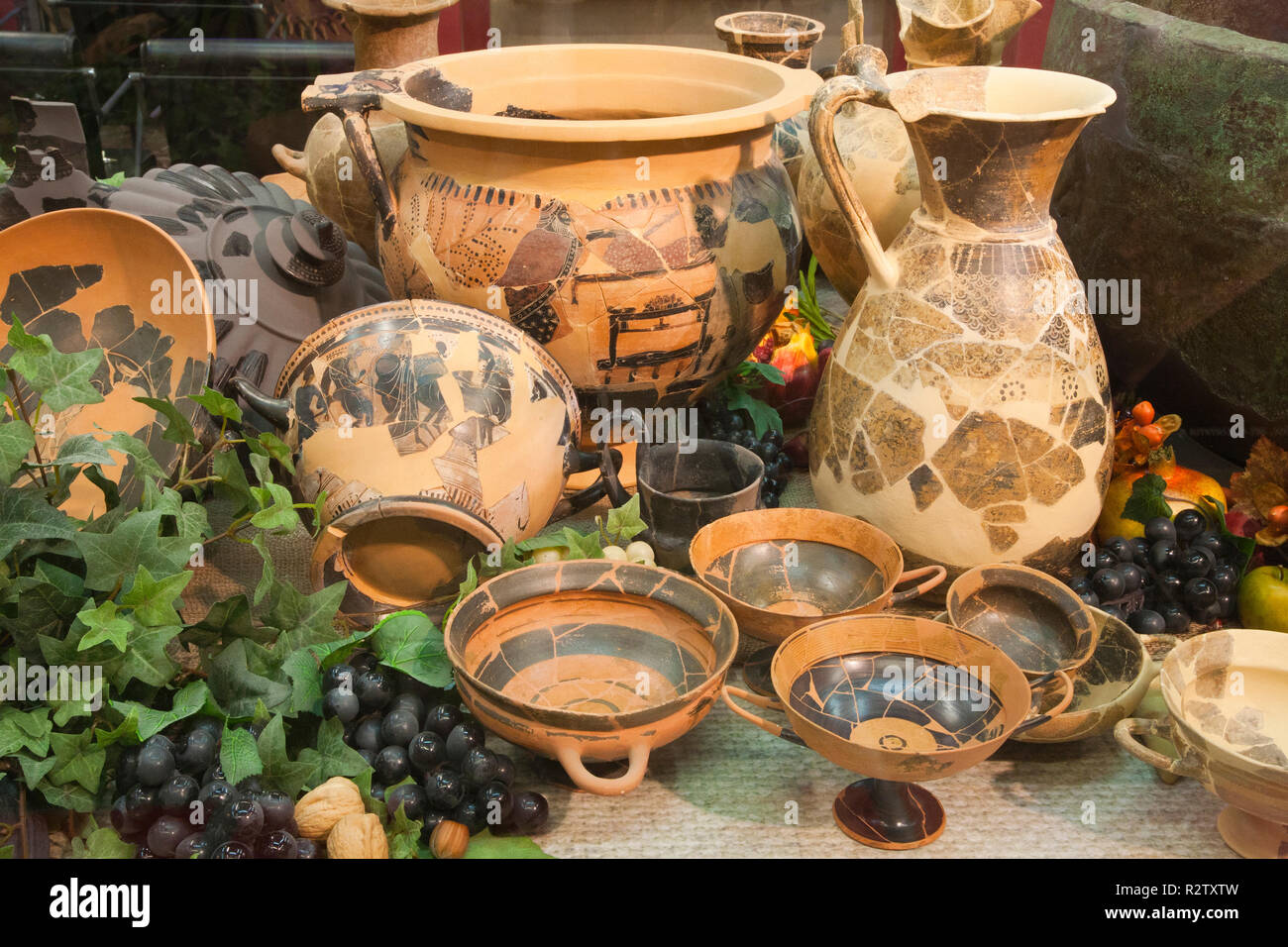 europe, italy, tuscany, vetulonia, archaeological museum, exibition, etruscan food, table laden with pots and utensils for banquet Stock Photo