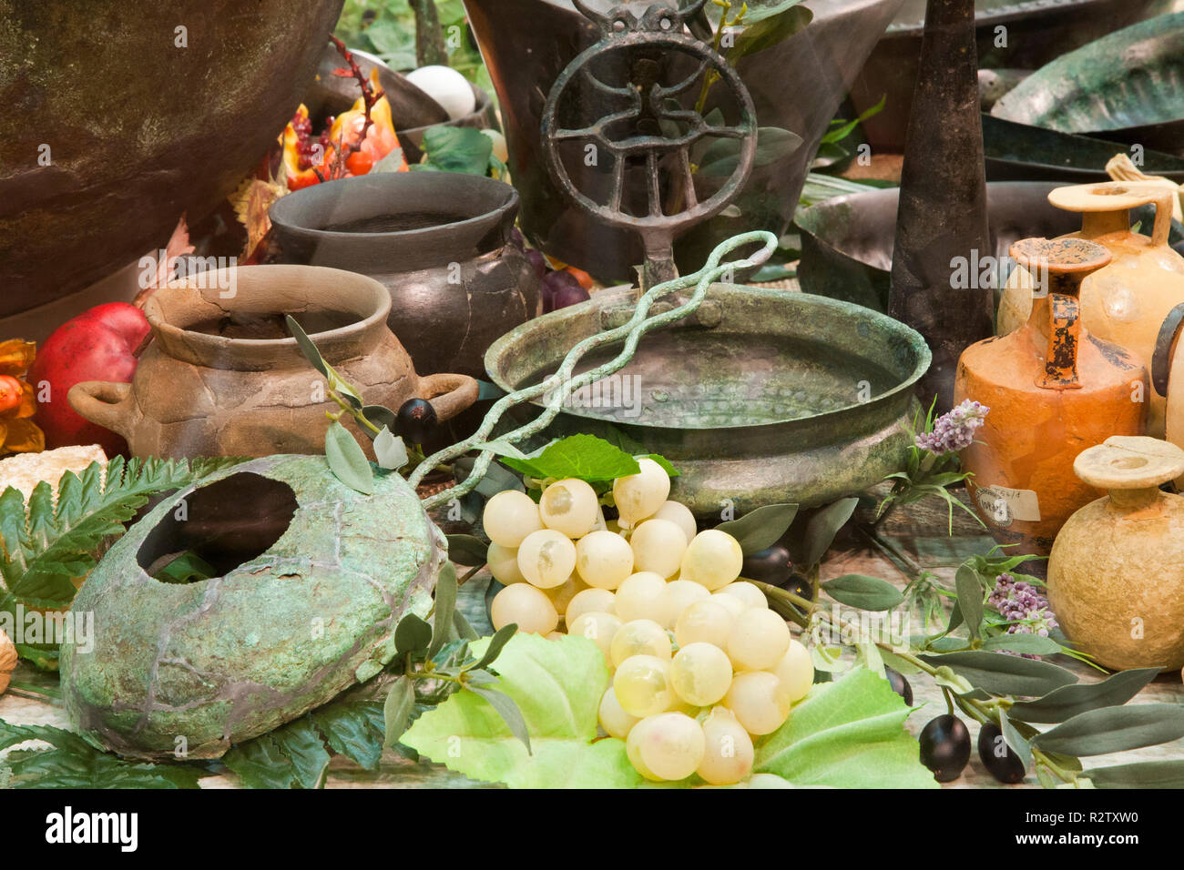 europe, italy, tuscany, vetulonia, archaeological museum, exibition, etruscan food, table laden with pots and utensils for banquet Stock Photo