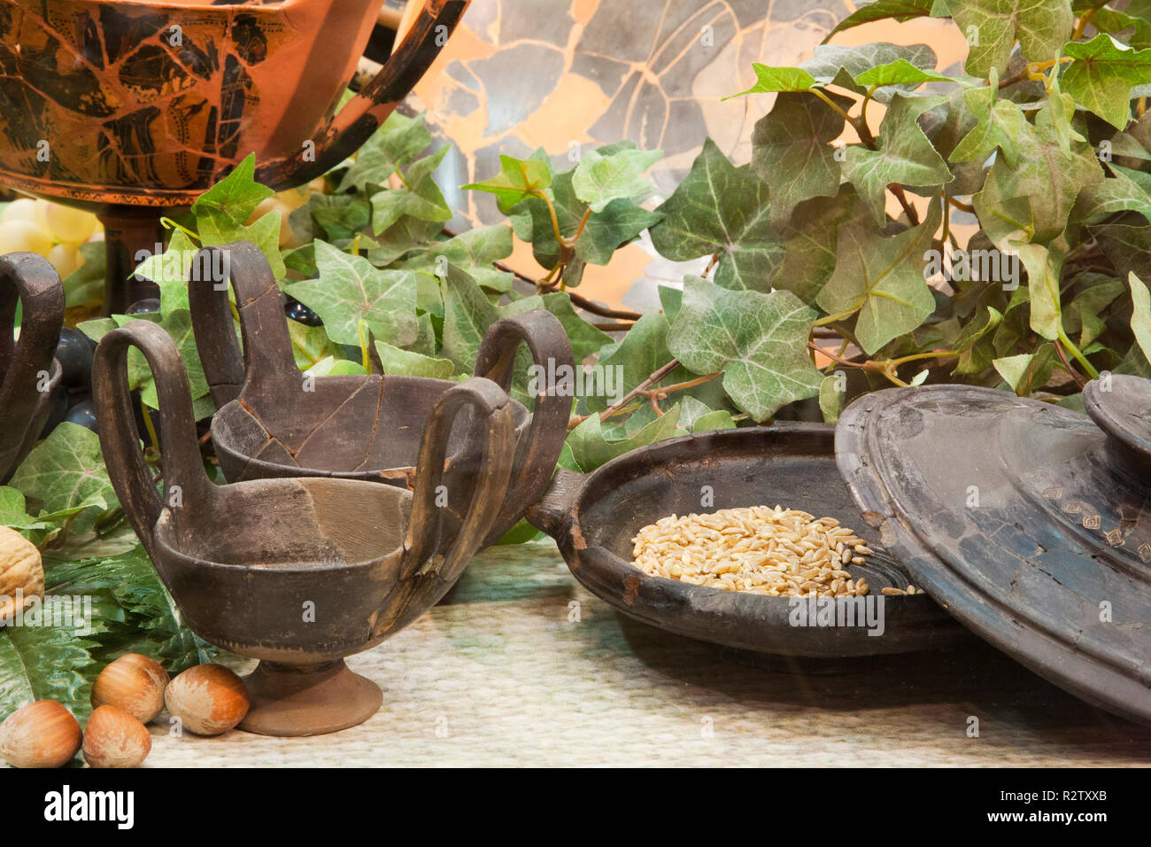 europe, italy, tuscany, vetulonia, archaeological museum, exibition, etruscan food, table laden with pots and utensils for banquet Stock Photo