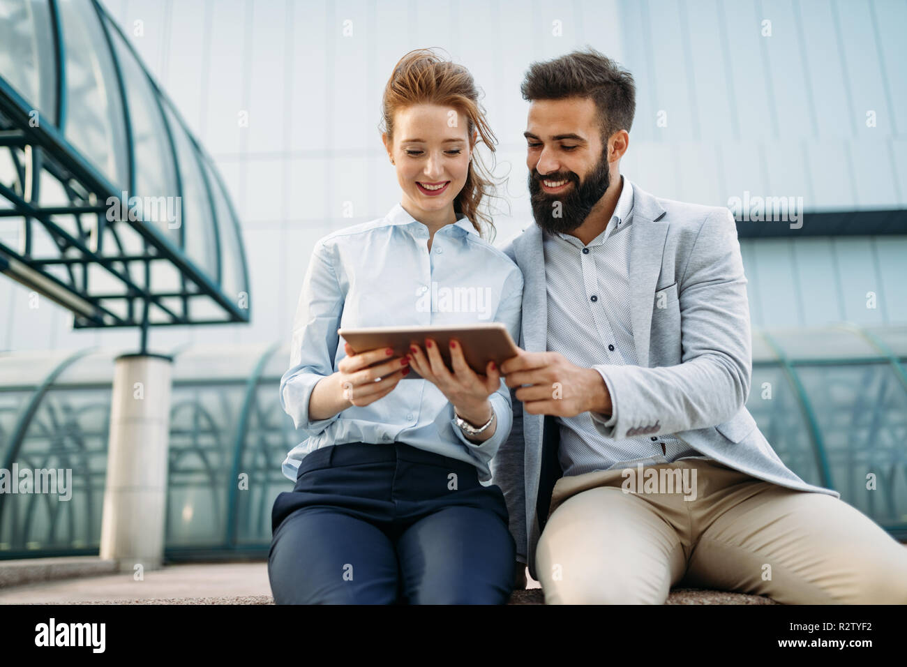 Young business couple walking outdoor near office building Stock Photo ...