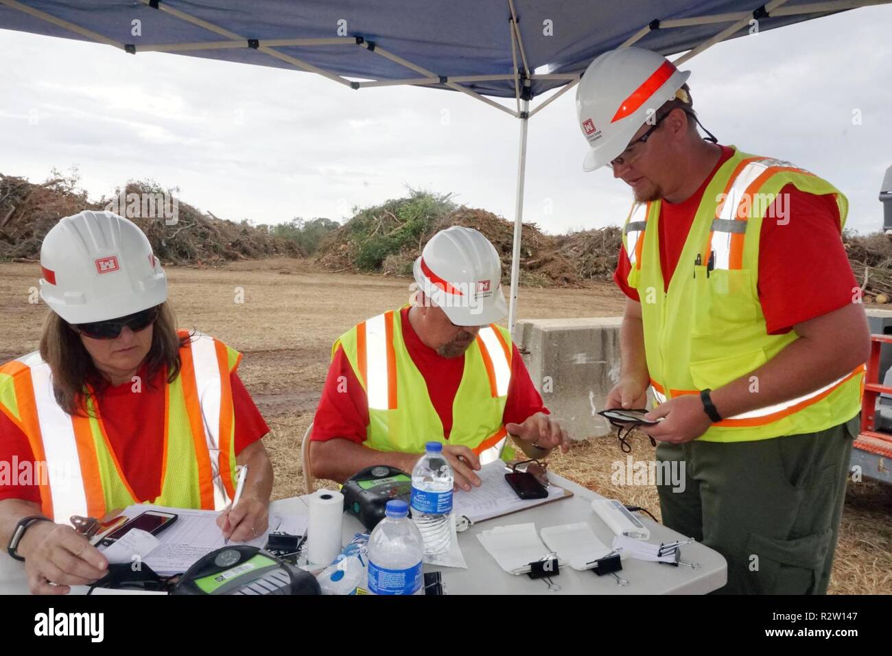 (Left) Kim Baker, from the Louisville District, Mike Holder, from Pittsburgh District and Robert Weiss, from the Louisville District are all quality assurance inspectors taking information and certify trucks at the Dougherty County, Ga., temporary debris, staging and reduction site. Stock Photo