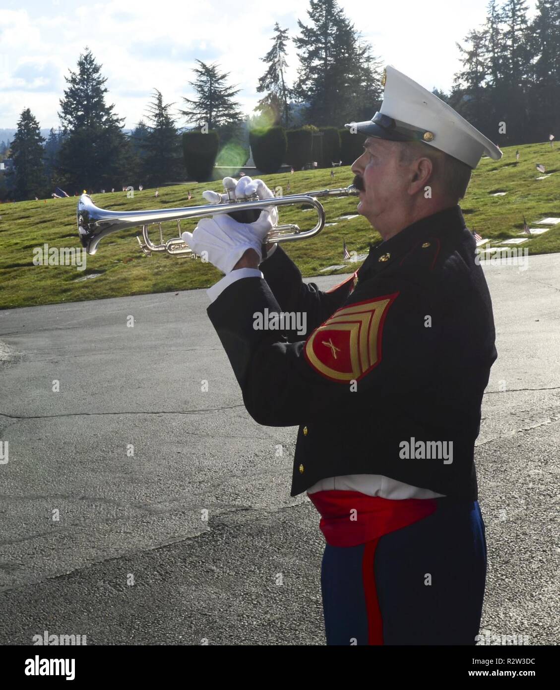 BREMERTON, Wash. (Nov. 10, 2018) Marine Corps veteran Glenn Gray, plays taps at Miller-Woodlawn in honor of Veterans Day. Miller-Woodlawn Funeral Home and Memorial Park holds an annual ceremony to commemorate prisoners of war, service members missing in action and veterans throughout Veterans Day weekend. Stock Photo
