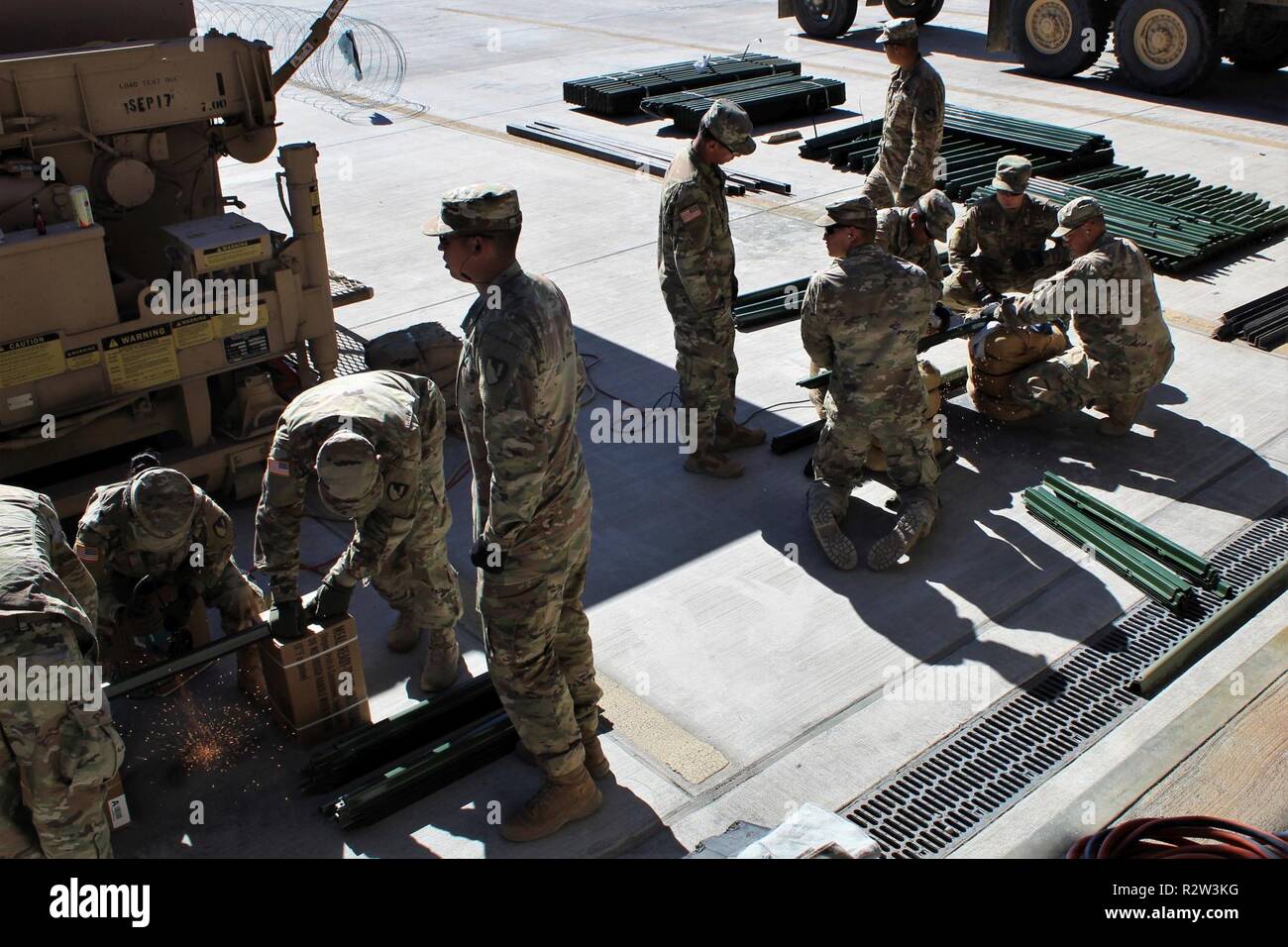 Soldiers from 104th Engineer Construction Company, 62nd Engineer Battalion, cut metal pickets