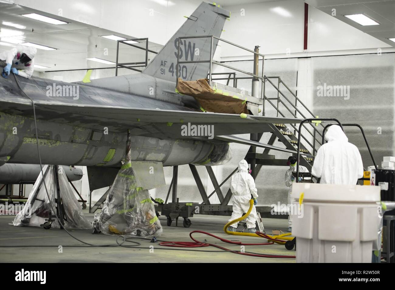 U.S. Airmen assigned to the 20th Equipment Maintenance Squadron corrosion control paint barn, work on an F-16CM Fighting Falcon at Shaw Air Force Base, S.C., Nov. 13, 2018. The maintenance performed on the aircraft helps protect the aircraft from the elements while stateside or overseas. Stock Photo
