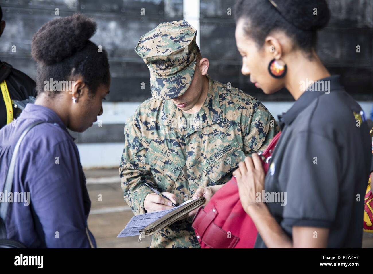 PORT MORESBY, Papua New Guinea (Nov. 14, 2018) Staff Sgt. Armando Lao records the names of arriving local media crew in the well deck of the amphibious transport dock ship USS Green Bay (LPD 20) prior to a press conference with Rear Adm. Brad Cooper, commander of Amphibious Force 7th Fleet. Green Bay is in Port Moresby preparing to assist with security efforts ahead of the Asia-Pacific Economic Cooperation (APEC) conference and is the second U.S. ship to visit Port Moresby in the last two months. Green Bay is part of Amphibious Squadron 11 and is operating in the region to enhance interoperabi Stock Photo