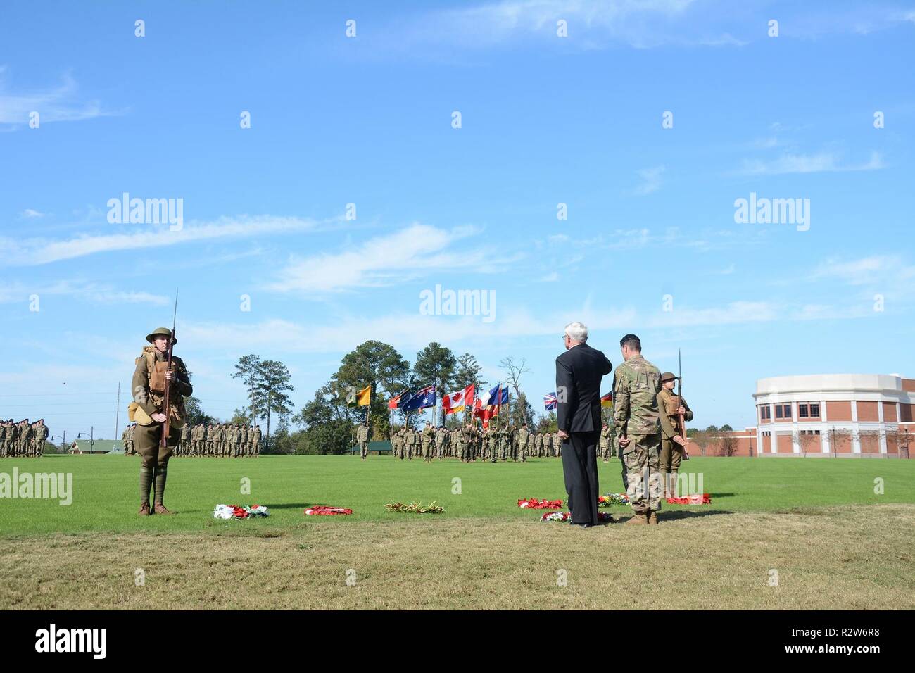 FORT BENNING, Ga. (Nov. 14, 2018) – Col. Douglas G. Vincent, foreground right, Maneuver Center of Excellence chief of staff, and Retired Army Lt. Gen. Thomas Metz, chairman and chief executive officer of the National Infantry Museum Foundation, lay wreaths during a Veterans Day / Armistice Day ceremony. Servicemembers from the U.S. Army, Navy, Air Force and Marines, and representing ten international militaries attended the World War I Veteran's Day Commemoration ceremony at the National Infantry Museum at Columbus, Georgia, Nov. 11, 2018. The ceremony honored the contributions of veterans fro Stock Photo