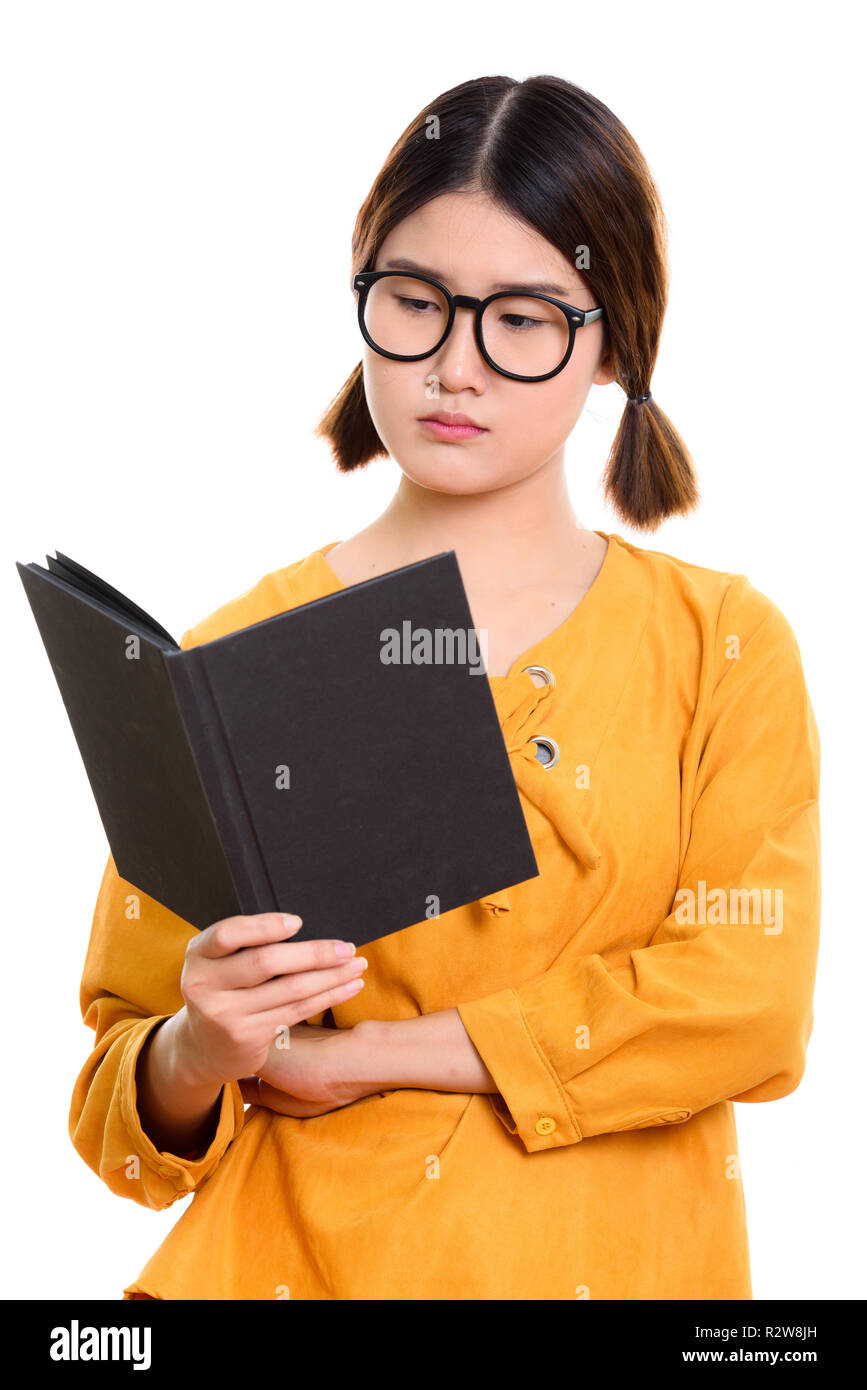 Young beautiful Asian student woman reading book Stock Photo