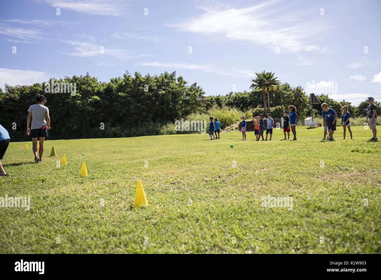 Students with Mokapu Elementary School play a traditional Hawaiian game at the Nu’ Upia Ponds during a field trip, Marine Corps Base Hawaii, Nov. 14, 2018. The base’s Environmental Department partnered with the school to host a cultural learning field trip to teach students the significance of the ponds and the Hawaiian culture. Stock Photo