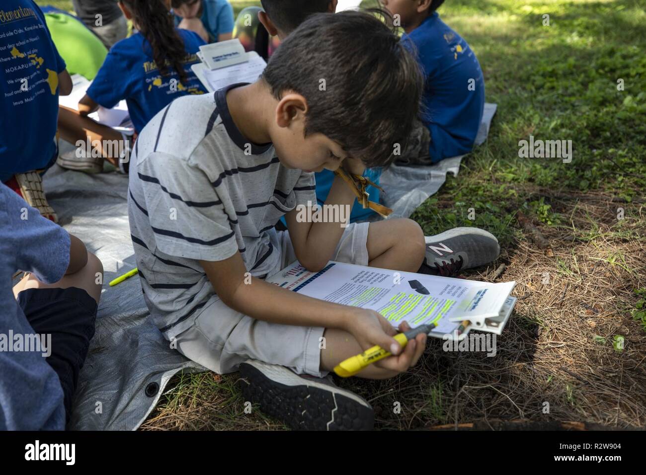 A student with Mokapu Elementary School works on a class assignment at the Nu’ Upia Ponds during a field trip, Marine Corps Base Hawaii, Nov. 14, 2018. The base’s Environmental Department partnered with the school to host a cultural learning field trip to teach students the significance of the ponds and the Hawaiian culture. Stock Photo