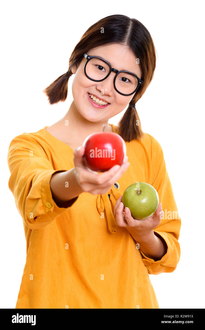 Young happy Asian woman smiling while holding green apple and gi Stock Photo