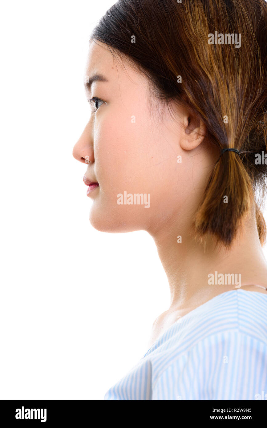 Profile view of face of young beautiful Asian woman Stock Photo