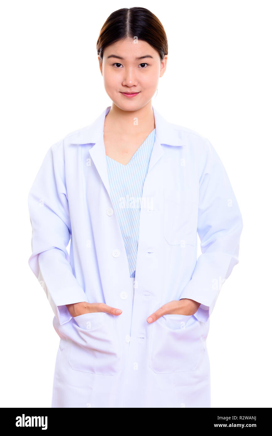 Studio shot of young beautiful Asian woman doctor standing with  Stock Photo