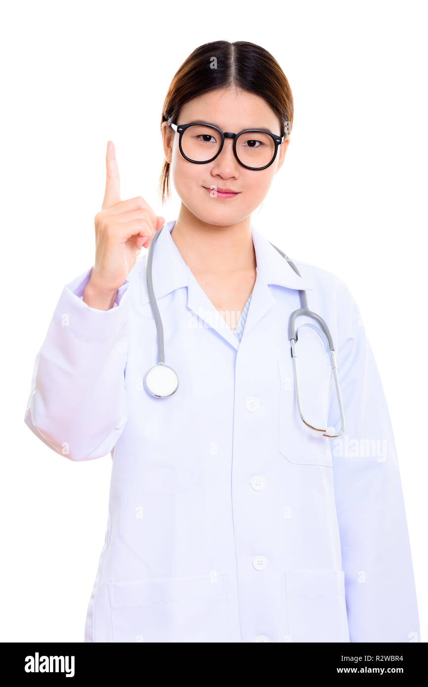 Studio shot of young beautiful Asian woman doctor pointing finge Stock ...