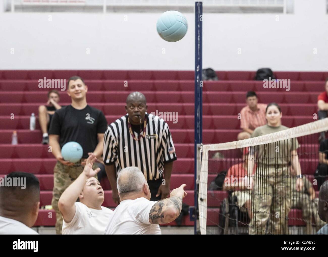 The ball is volleyed across the net as competitors prepare to react during the seated volleyball competition at the Pacific Regional Trails on November 15, 2018 at Schofield Barracks Hawaii. Adaptive reconditioning activities can be an integral part of a Soldier’s Comprehensive Transition Plan and help to build resilience, strengthen Relationships and improve self-confidence. Stock Photo