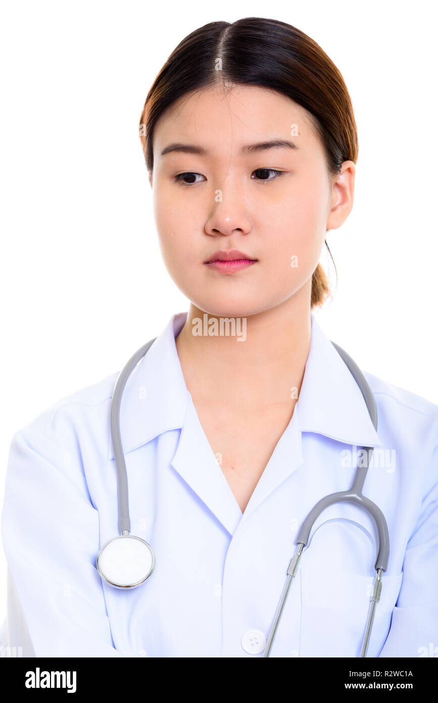 Studio shot of young beautiful Asian woman doctor thinking while Stock ...