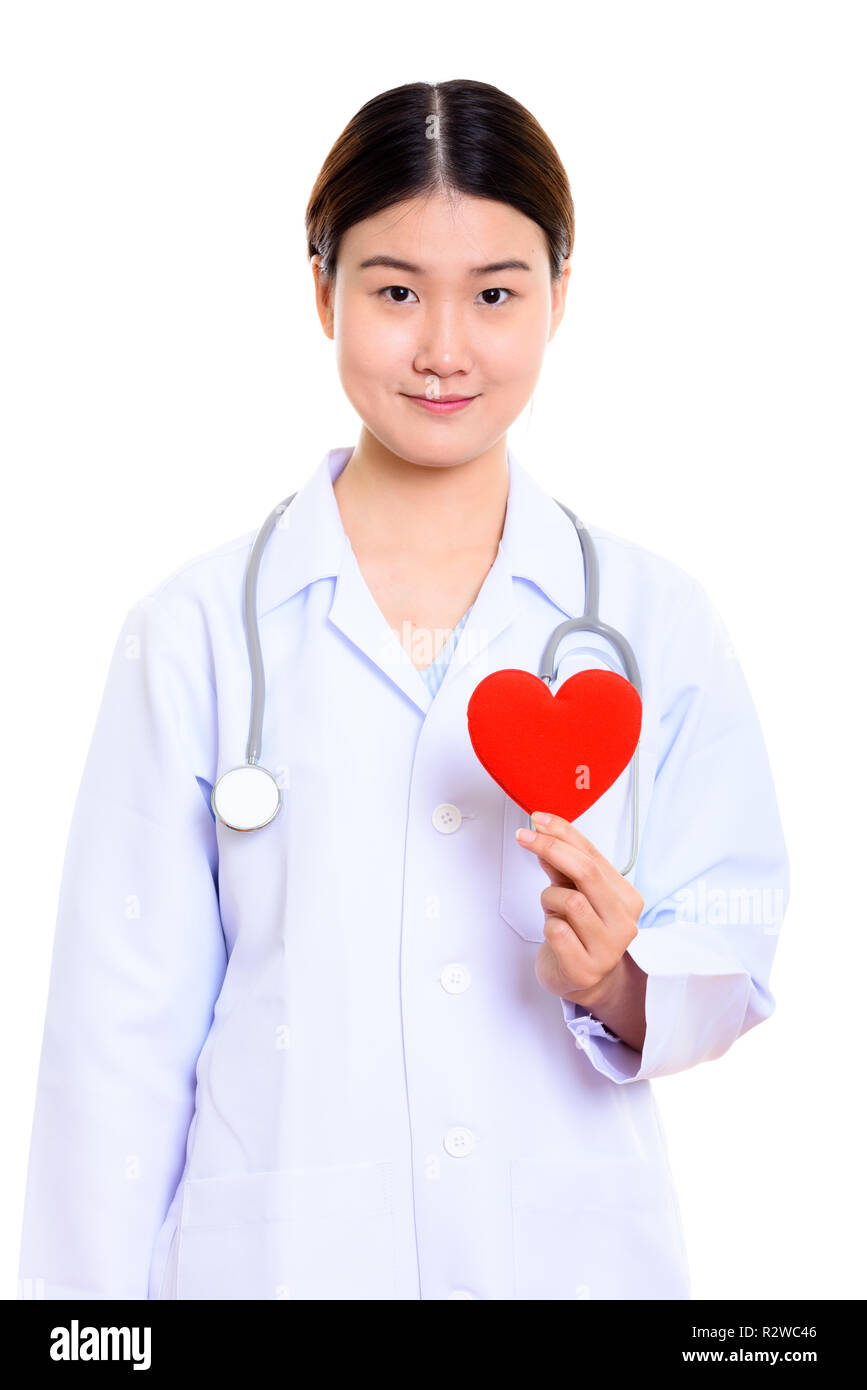 Young beautiful Asian woman doctor holding red heart Stock Photo - Alamy