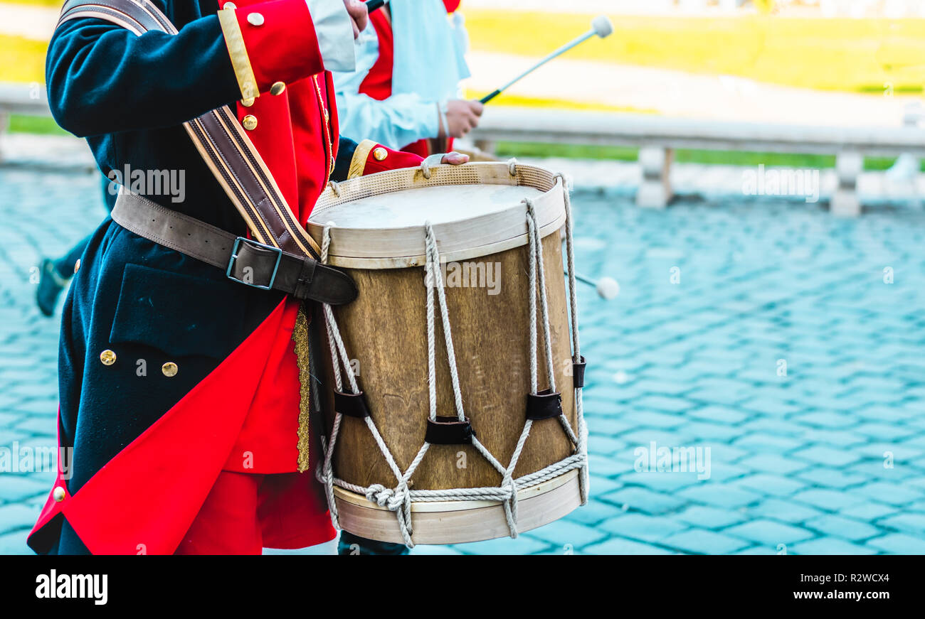 Member of a military fanfare playing a mobile bass drum Stock Photo