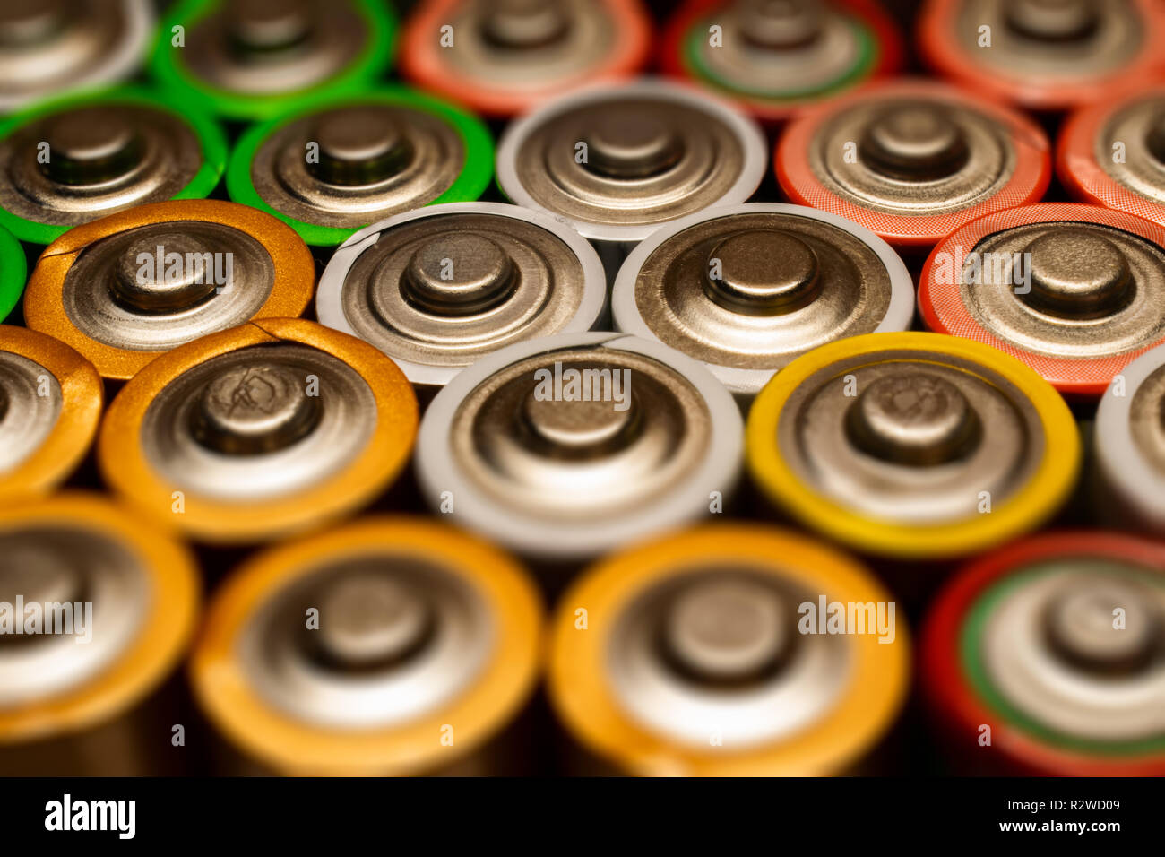 Closeup of pile of used alkaline batteries. Close up colorful rows of selection of AA batteries