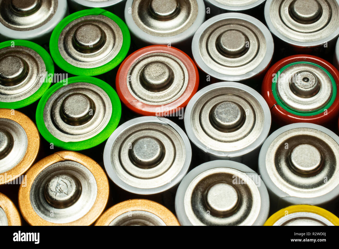 Closeup of pile of used alkaline batteries. Close up colorful rows of