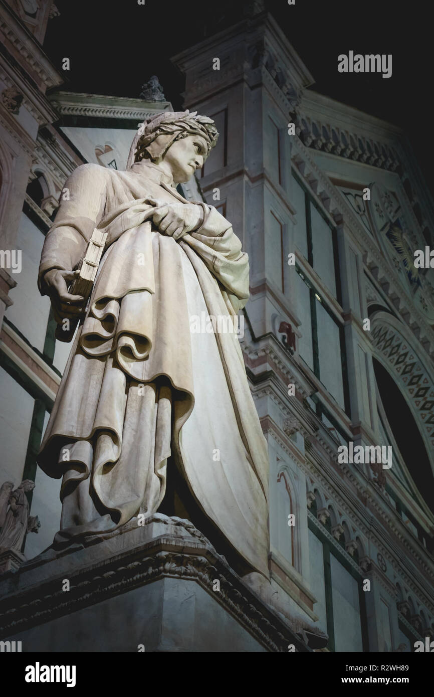 Florence, Italy - December 2017. Marble statue of the famous Italian medieval poet Dante Alighieri in front of the Basilica di Santa Croce. Stock Photo