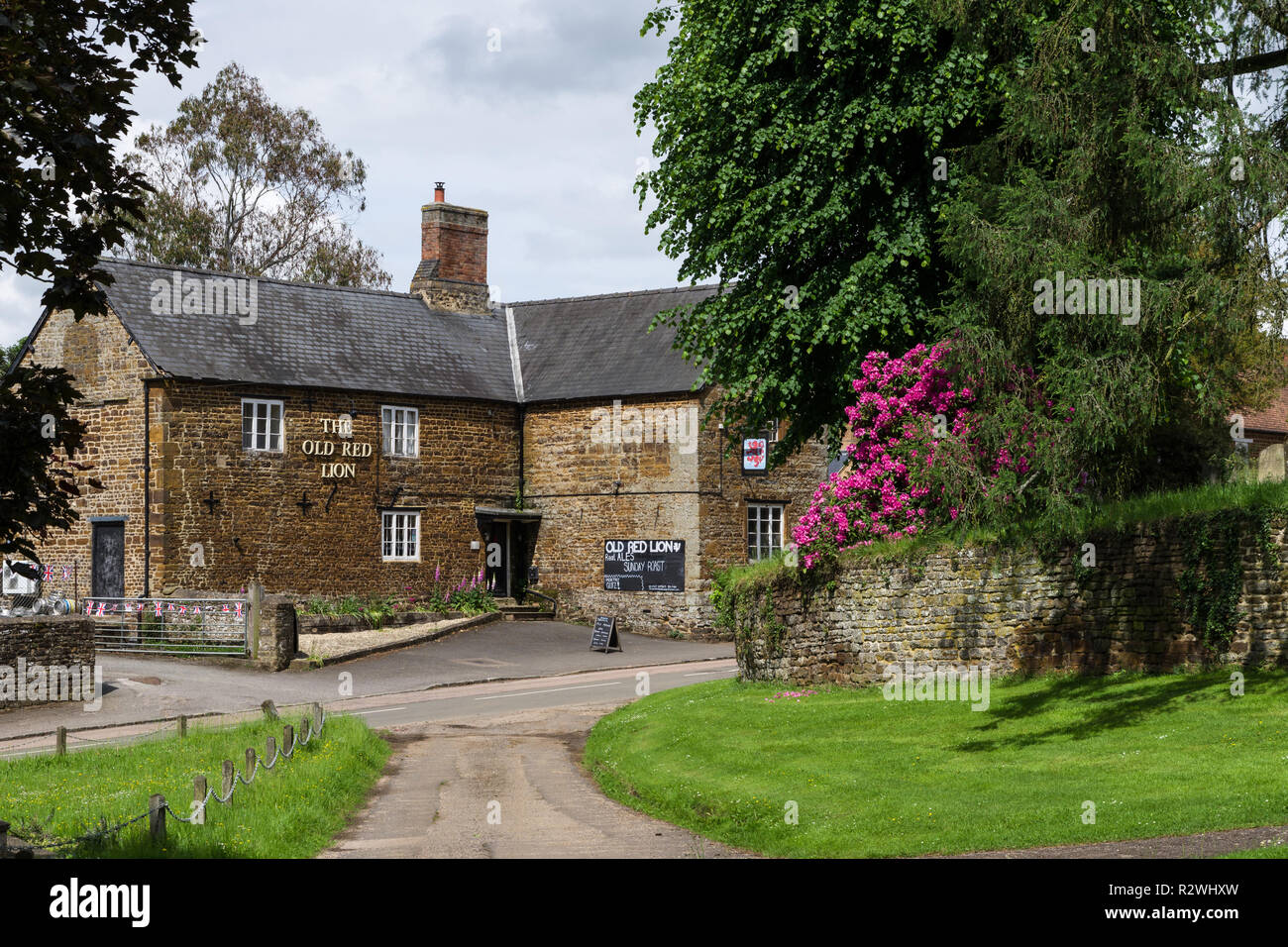 A view across the green to The Old Red Lion, a traditional village pub, Litchborough, Northamptonshire, UK Stock Photo