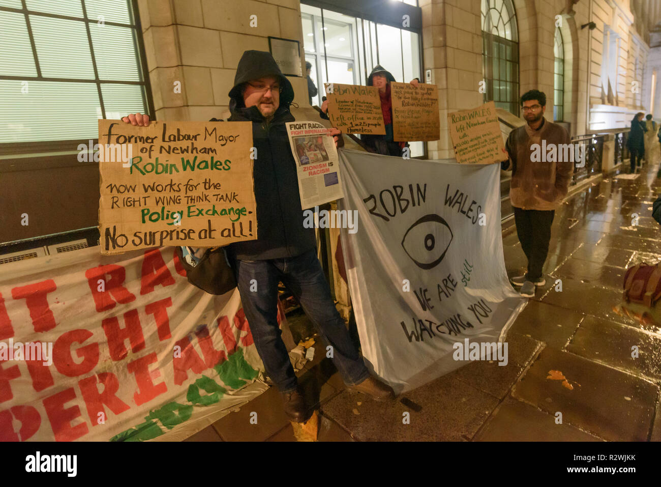 London, UK. 19th November 2018. Protesters from Focus E15 Mothers protest in the rain at centre right think tank Policy Exchange where former Newham Mayor Robin Wales now works and was speaking at a conference. They say he left office with 1 in 25 homeless including 2,000 families with children under 5, left the largest council bank debt of any local authority, kept hundreds of council homes empty for 10 years despite a huge waiting list and deleted 10,000 e-mails to avoid investigation. Policy Exchange brought out tea for the protesters who were going inside as I had to leave. Stock Photo