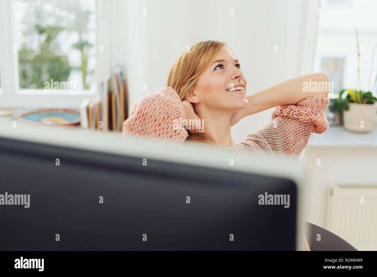 Woman leaning back in chair hi-res stock photography and images - Alamy