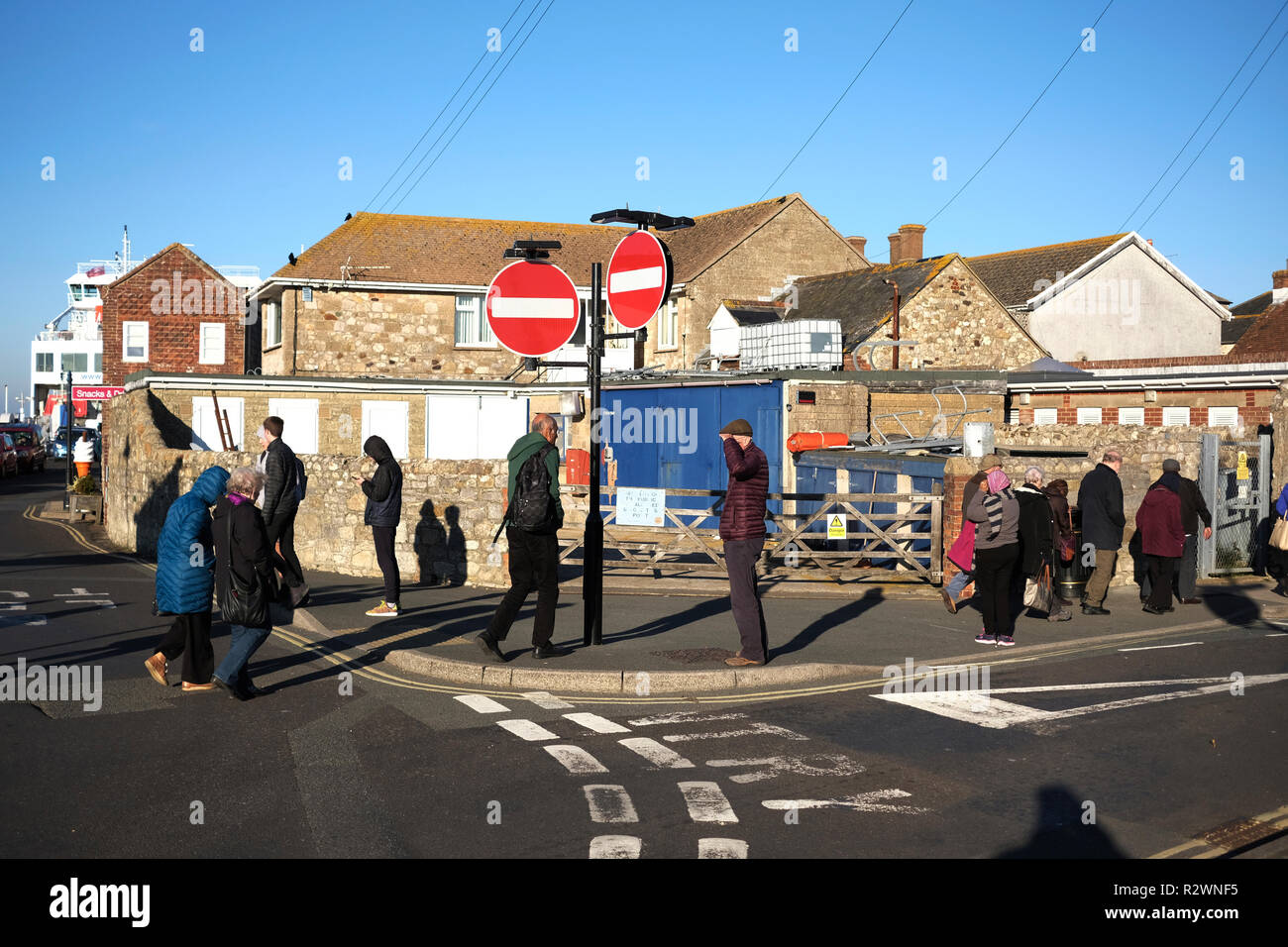 Daytrippers visit Yarmouth Isle of Wight crossing the road at the