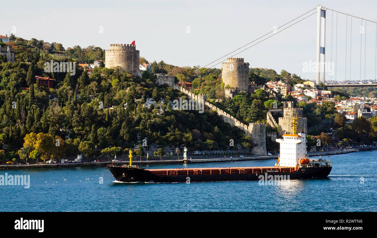 Transportation ship passing by the Rumeli Fortress in Istanbul,Turkey. Stock Photo