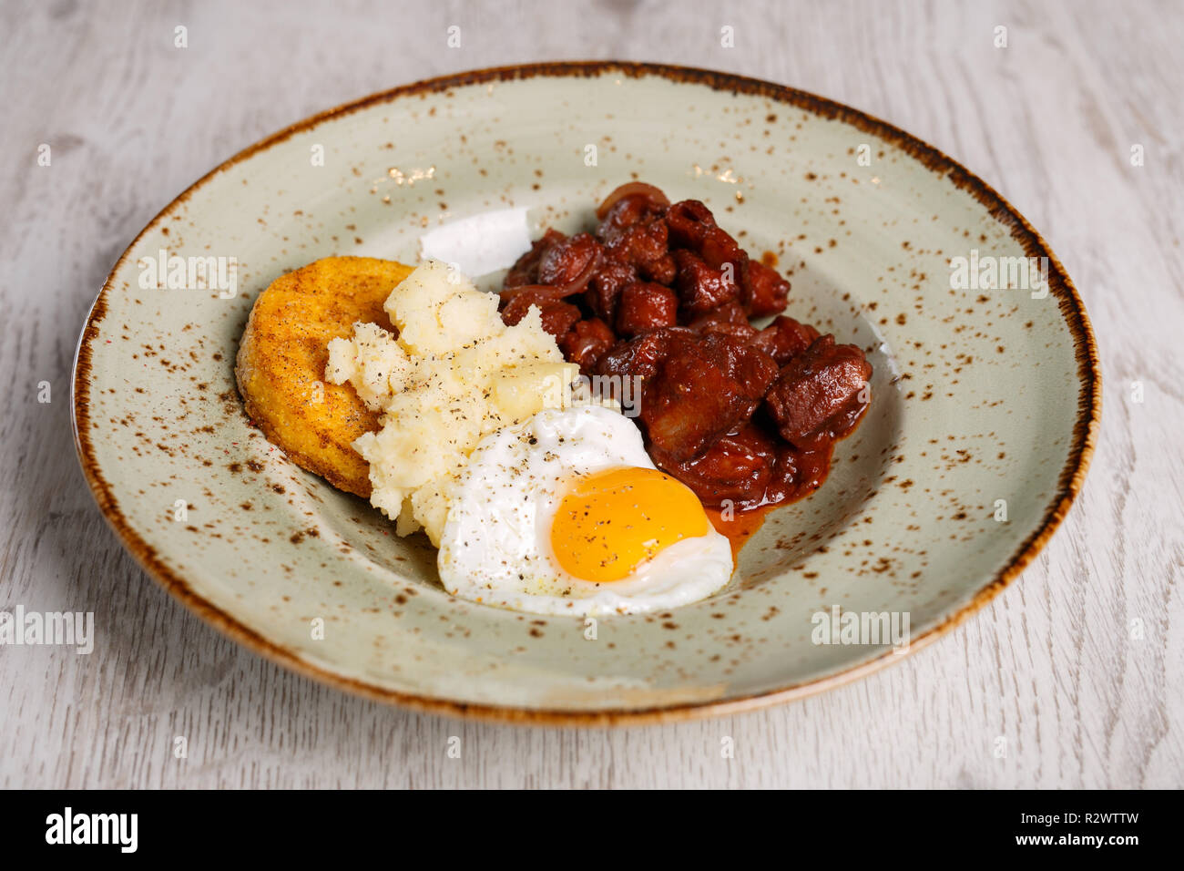 Romanian traditional food, polenta with fried egg and spicy meat and