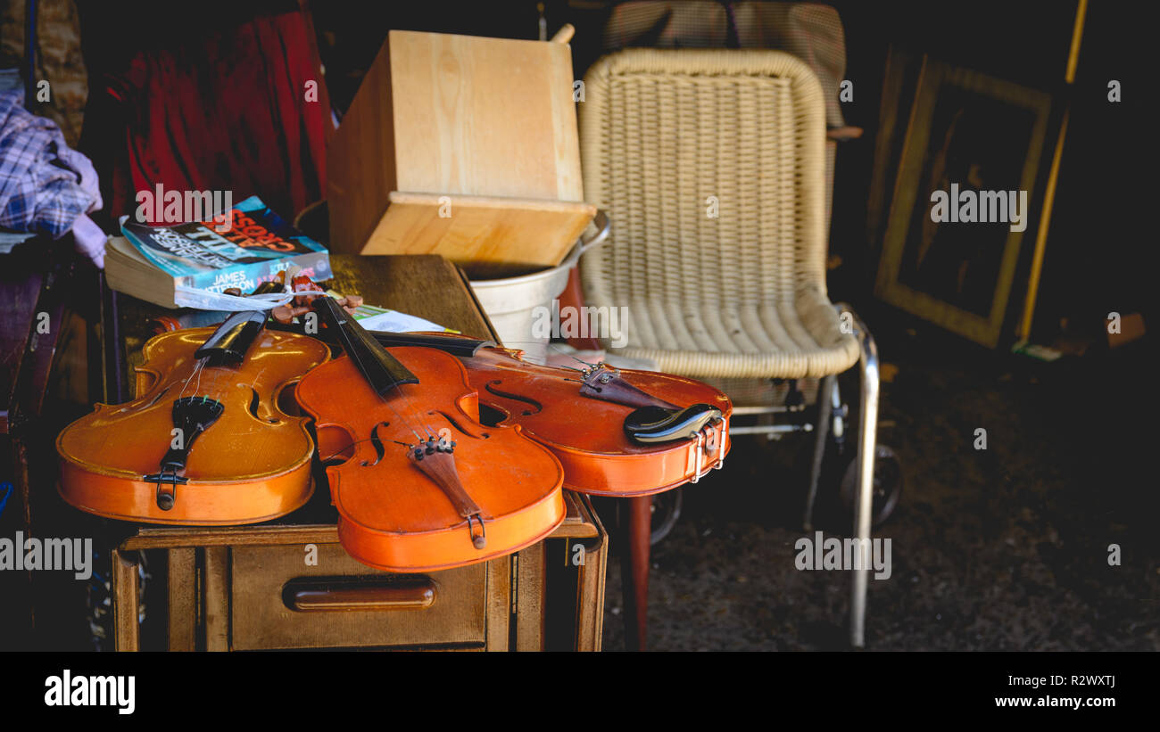 London, UK - February, 2019. Old violins on sale in flea market near Brick Lane in Shoreditch. Stock Photo