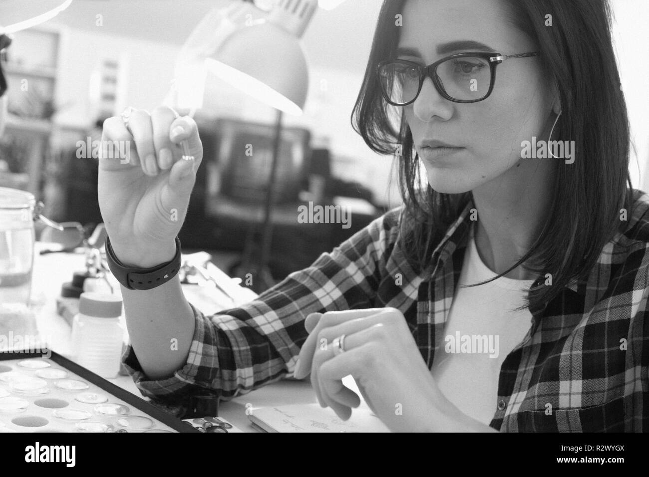 Jeweler at work, crafting in a jewelry workshop. Stock Photo
