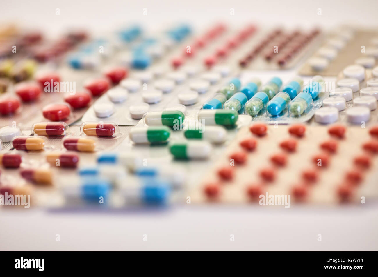Many colorful medicines lie side by side in blister packaging Stock Photo