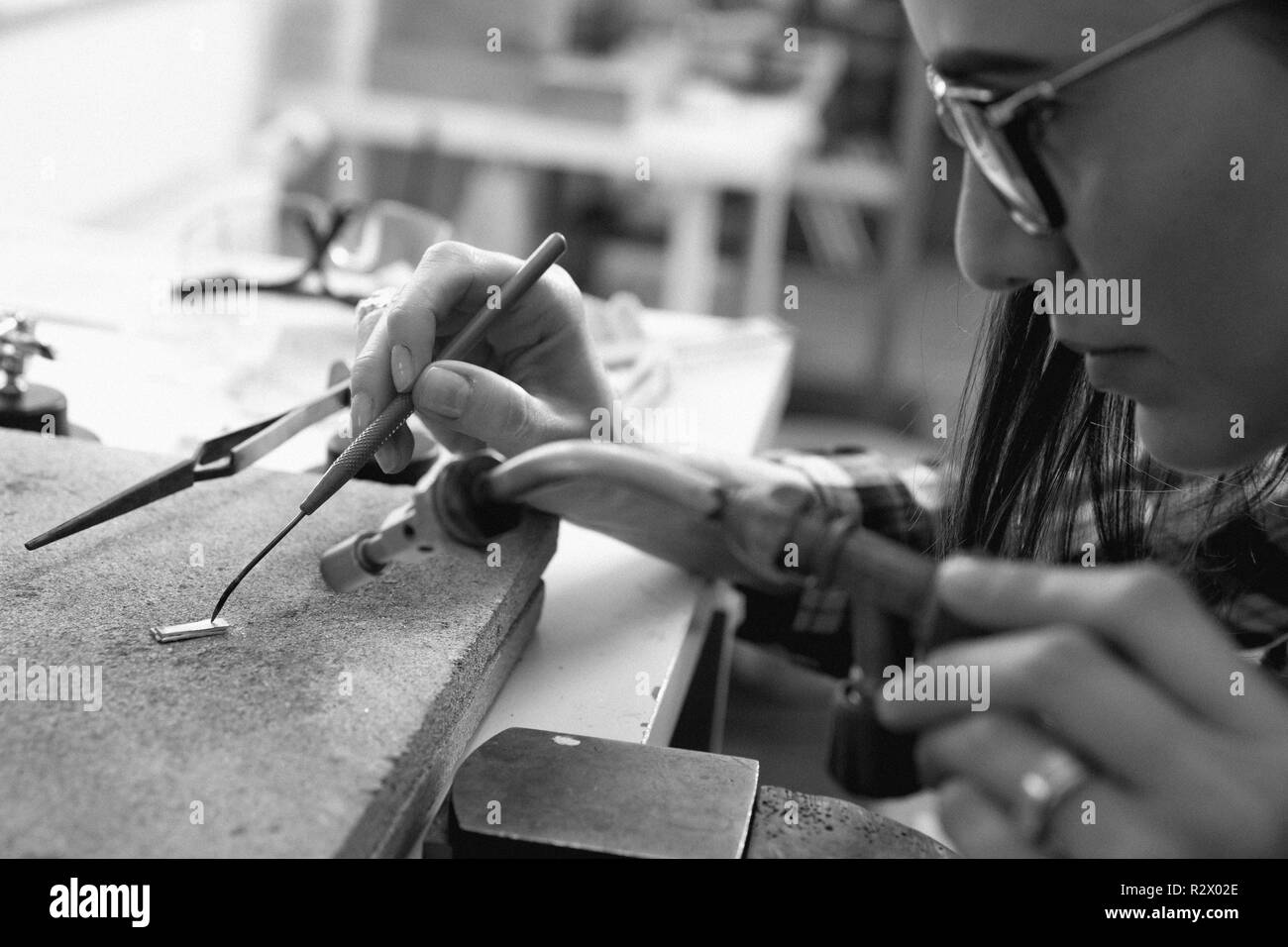 Jeweler at work, crafting in a jewelry workshop. Stock Photo