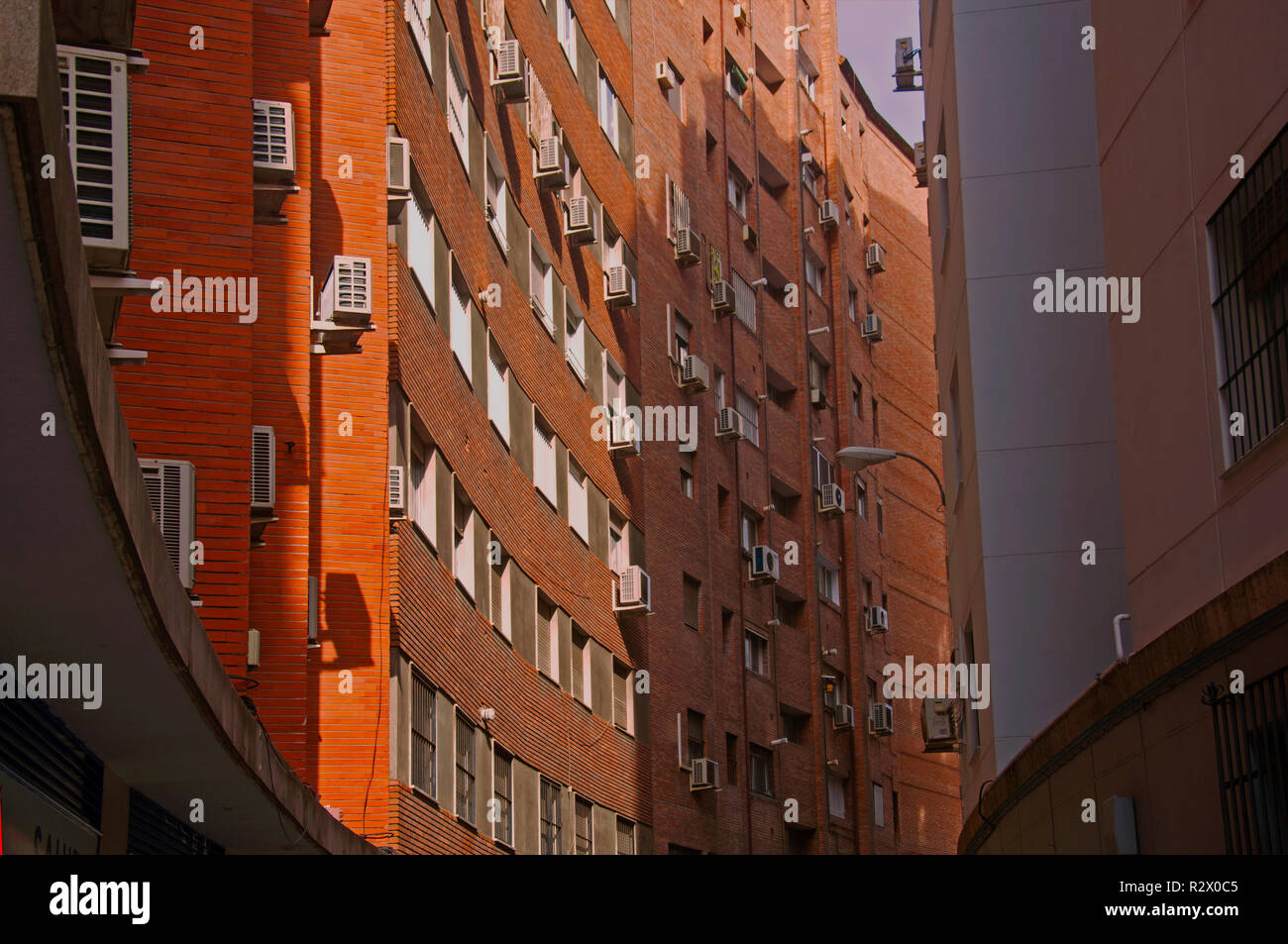 Orange brick building with concave wall, summer Stock Photo