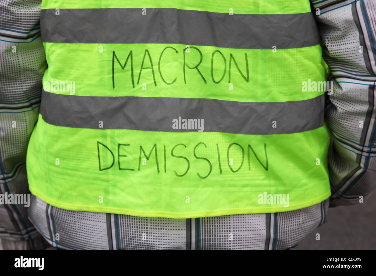 Yellow vests protest against higher fuel prices in France and text on the yellow vest president Macron departure in French Stock Photo