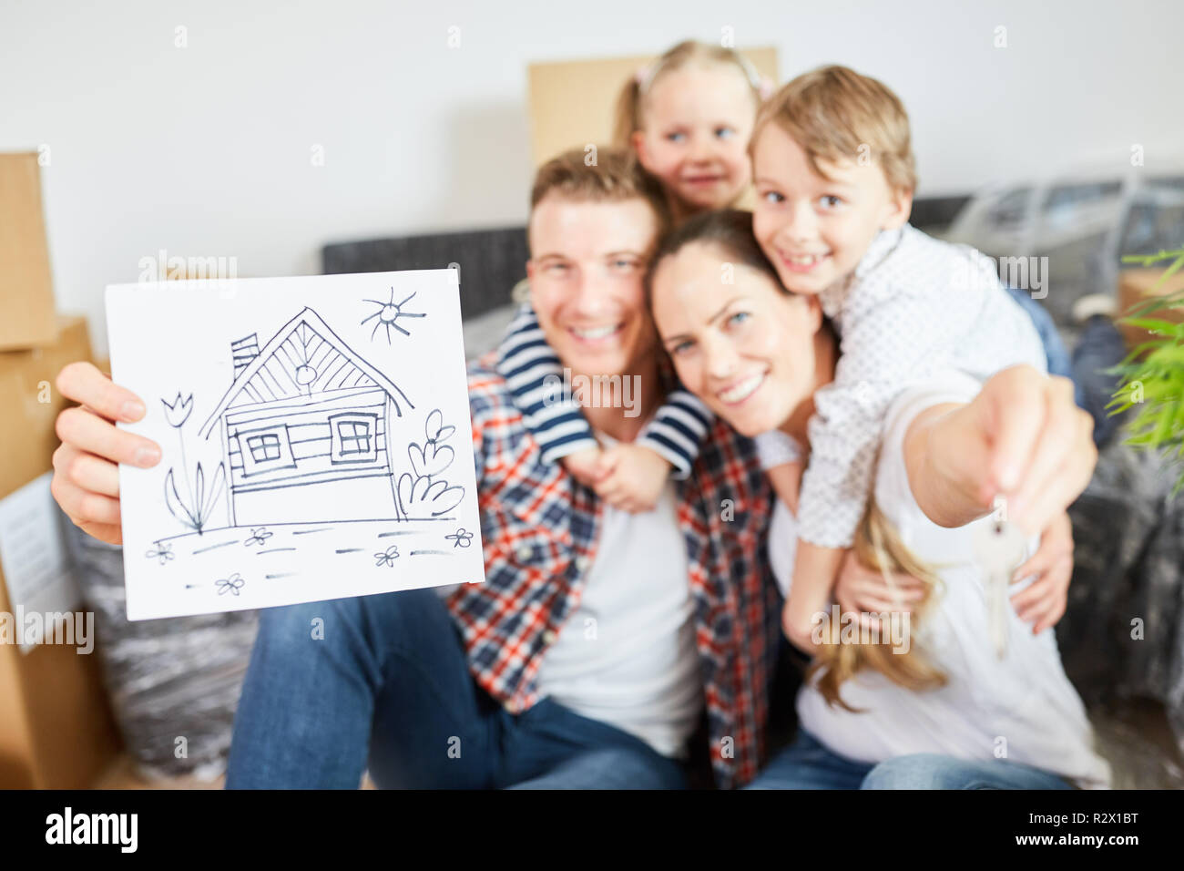 Happy family and children show picture as a symbol for home and house purchase Stock Photo